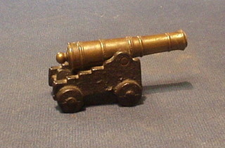 A 19th Century brass barrelled canon with 3 1/2" barrel raised on an iron trunion