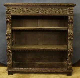 A Victorian carved dark oak open bookcase, the upper section fitted a drawer above adjustable shelves 42"