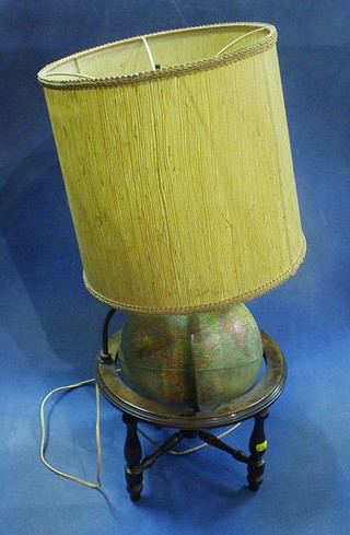 A Reploglo 10" reference globe mounted in  a turned walnutwood stand and with light fitting