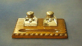 A 19th/20th Century rectangular oak ink stand with 2 cut glass inkwells