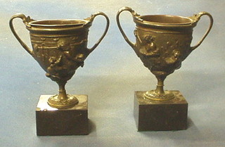 A pair of 19th Century fine quality cast bronze twin handled urns, decorated a half man/half horse, raised on marble bases 8"