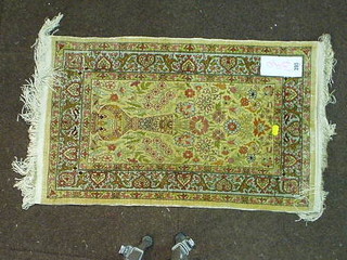 A fine quality Persian silk rug decorated a vase of flowers within multi row borders 26" x 17"