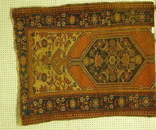 A Caucasian rug with diamond medallion within multi-row borders 66" x 38"