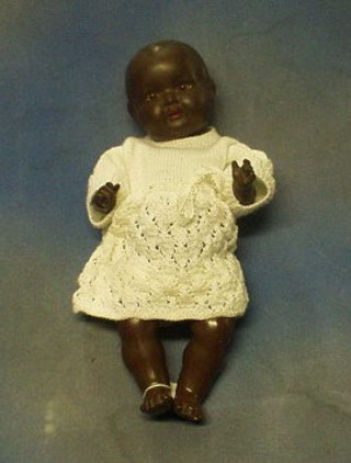 Armand Marseille porcelain headed black baby, the head incised AM Germany 518/3 1/2