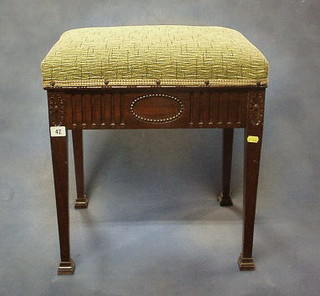 A Victorian mahogany box seat piano stool with hinged lid, on square tapering supports and spade feet