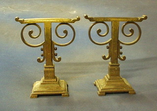 A pair of brass Art Nouveau fire dogs