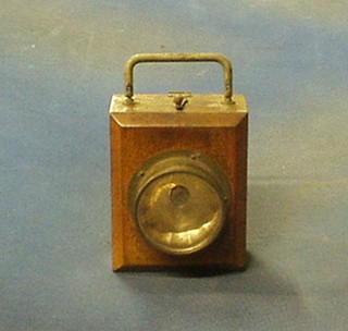 An early Ever Ready torch contained in a mahogany case