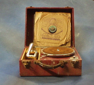 A portable manual gramophone contained in a green fibre case