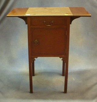 A Georgian style mahogany drop flap bedside table fitted a drawer above a cupboard, raised on square tapering supports 16"