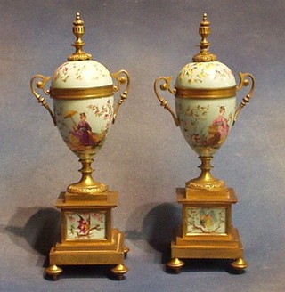 A pair of 19th Century Continental porcelain lidded urns with gilt ormolu mounts, 12" high