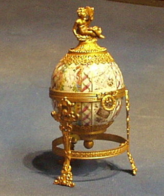 A 19th Century Continental porcelain trinket box in the form of an egg with gilt metal mounts (very f) 8"