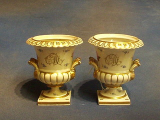 A pair of 19th Century porcelain twin handled urns of campanular form with gilt banding and floral decoration, 5" (1 handle r)