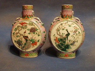 A pair of 19th Century famille vert porcelain twin handled moon flasks decorated birds amidst flowering branches 11"