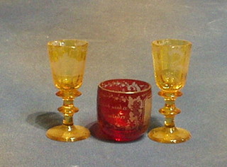 A red Bohemian etched glass beaker 2" and 3 Bohemian yellow glass glasses 4" (some chips to the bases)