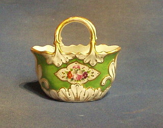 A 19th Century porcelain vase in the form of a green glazed basket with decorative floral painted panels 5"