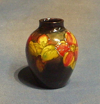 A Moorcroft columbine patterned vase, the base with slight firing crack, marked Moorcroft England, 5"