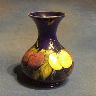 A Moorcroft Wysteria pattern club shaped vase, the rim F and R, the base impressed Moorcroft and with signature 7"