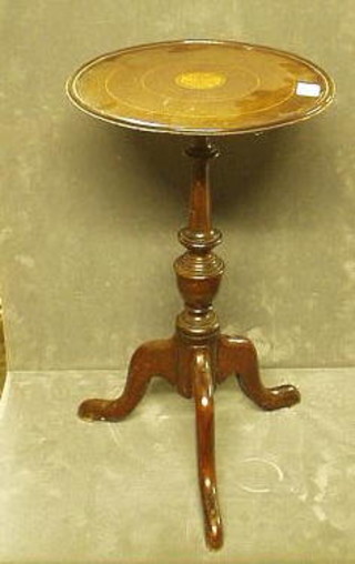 An Edwardian circular inlaid mahogany wine table raised on pillar and tripod supports