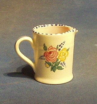 A circular Poole Pottery jug with floral decoration, impressed Poole England 323 3"