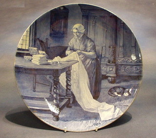 A 19th Century Delft pottery plate by Uoost Thooft & Labouchere, decorated lady sewing,  (repaired chip)