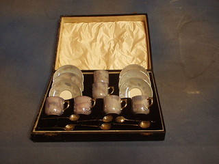 A German 6 piece blue lustre and gilt banded coffee service with 6 silver bean end coffee spoons, cased