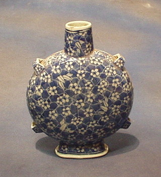 An Oriental blue and white prunus pattern twin handled moon flask 9"