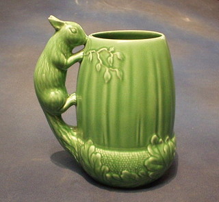 A Sylvac green glazed jug the handle decorated a squirrel, base incised 1115 8"