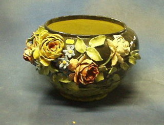 A 19th/20th Century circular pottery jardiniere with floral encrusted decoration, the base marked BG 14"