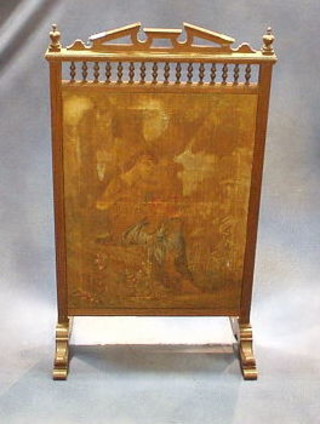 An Edwardian oak fire screen with bobbin turned decoration and "tapestry" panel