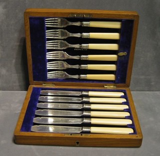 A set of 6 silver plated fish knives and forks contained in an oak canteen box