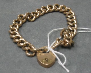 A lady's 9ct hollow gold curb link bracelet with padlock clasp