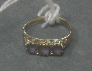 A lady's 9ct gold dress ring set 3 oval cut amethysts and 4 diamonds