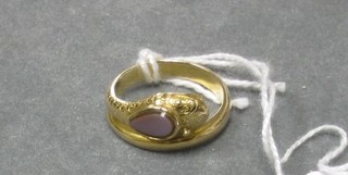 A lady's "gold" dress ring in the form of a serpent set a hardstone