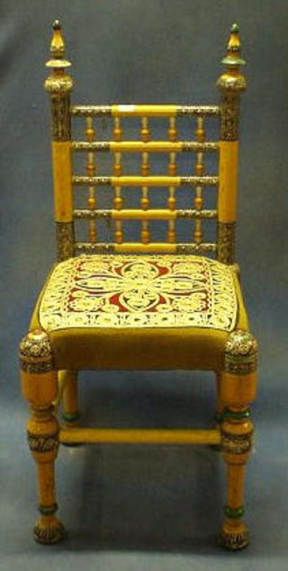 A pair of Victorian carved and ebonised chairs with upholstered seats and backs, on cabriole supports