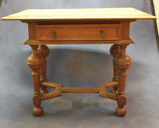 A Jacobean style honey oak low boy fitted a drawer raised on bulbous turned supports with Y shaped stretcher on bun feet 37"