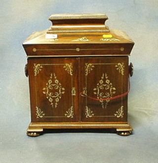 A Victorian  rosewood and inlaid mother of pearl sarcophagus shaped vanity box with hinged lid, the interior fitted 2 jewellery drawers and a writing slope enclosed by panelled doors with carved tore handles, raised on bracket feet 12"