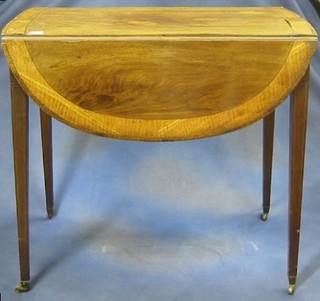 A handsome Georgian mahogany oval Pembroke table with crossbanded top, fitted a drawer and raised on square tapering supports ending in brass caps and castors 30"