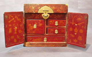 An Eastern red lacquered cabinet, the interior fitted drawers 14"