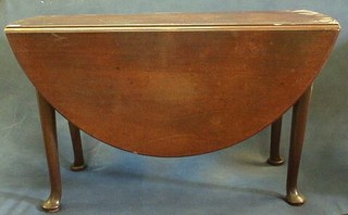 A Georgian mahogany oval drop flap gateleg dining table raised on pad feet 39"