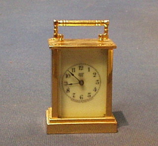 An American Waterberg Clock Co.? miniature carriage clock with enamelled dial and Arabic numerals contained in a gilt metal case 3"