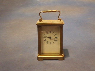 A French 8 day carriage clock with enamelled dial and Roman numerals contained in a gilt metal case 4 1/2"