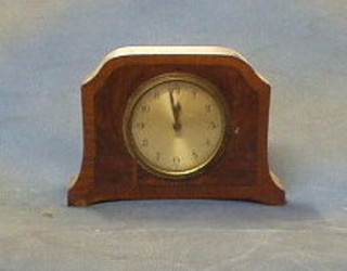 A 1930's 8 day Continental bedroom timepiece with silvered dial and Roman numerals in a walnutwood case