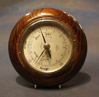 A circular aneroid barometer with silvered dial 7"