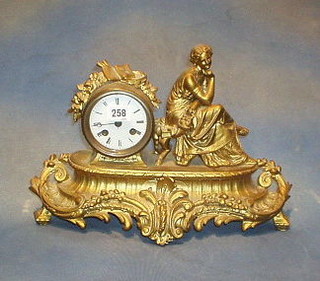 A 19th Century striking mantel clock contained in a gilt painted spelter case in the form of a lady