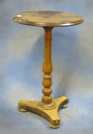 A 19th Century turned mahogany wine table raised on a turned column with triform base