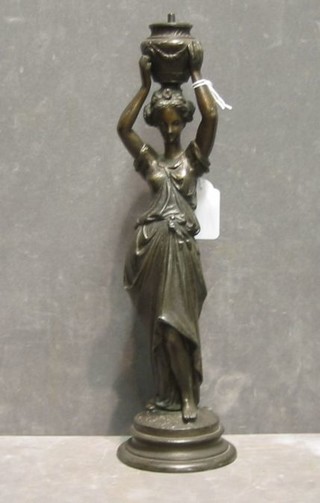 A spelter figure in the form of a lady supporting an urn 12"