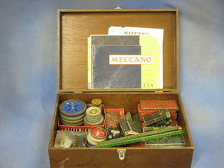 A collection of green and red Meccano with various wheels, etc, Meccano pamphlets, outfits 2,3,4,5 and 7