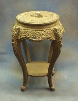 A circular Oriental ebonised 2 tier jardiniere stand raised on cabriole supports 16"