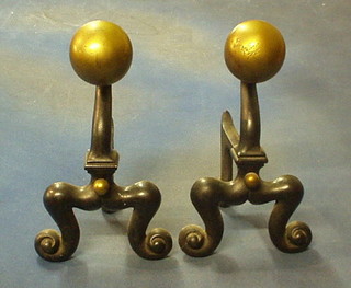 A pair of iron brass Dutch style fire dogs