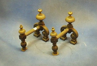 A pair of reeded brass fire dogs